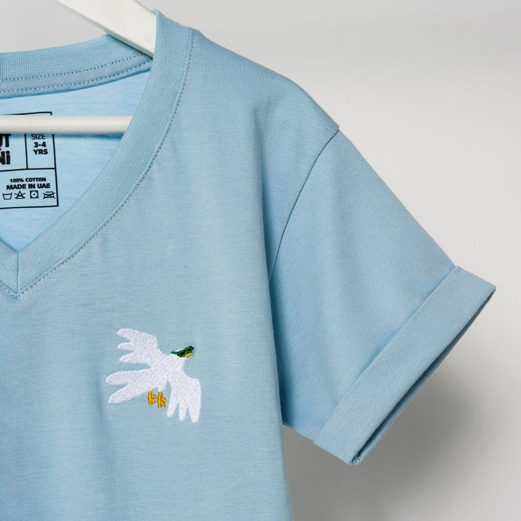 Light blue t-shirt with a white dove embroidered on it, displayed against a light gray background.