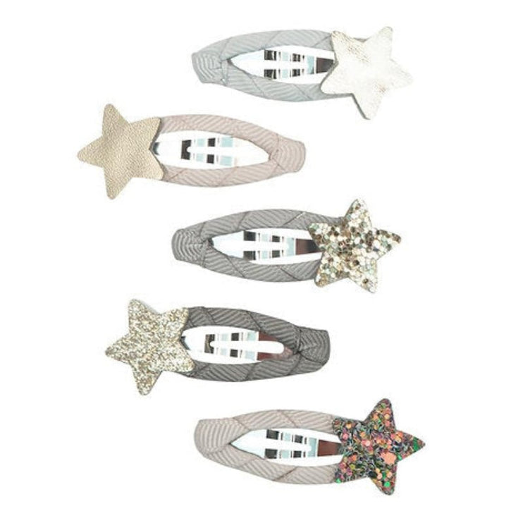 Set of five star-shaped hair clips with various designs on a white background