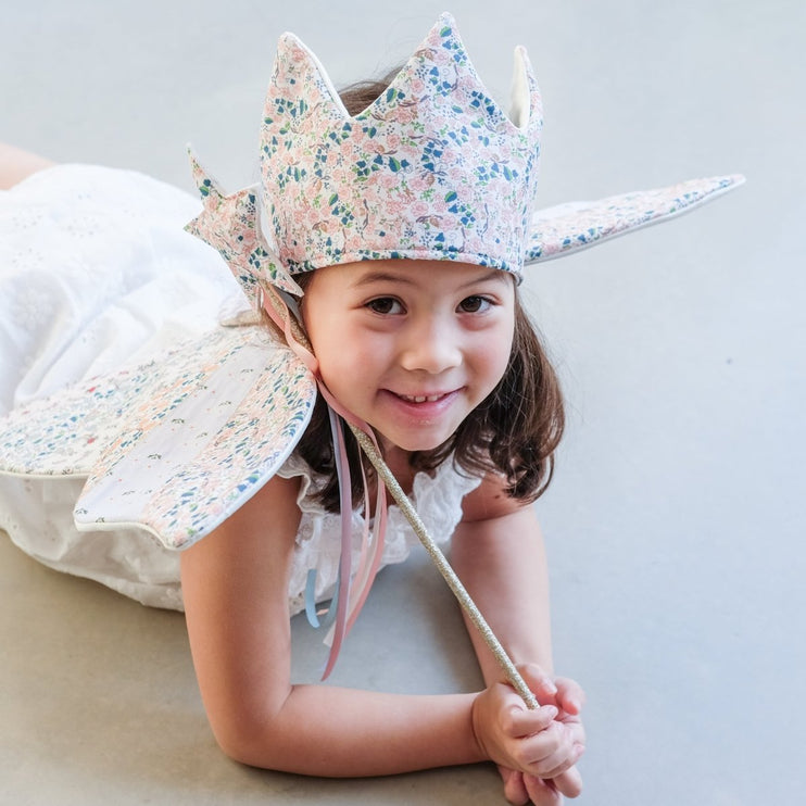 Child wearing a floral crown with a white background