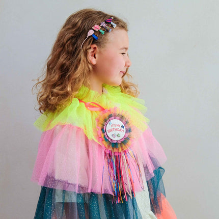 a kid with birthday mini clips on her hair