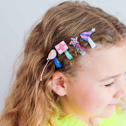 a kid with cute hair clips on her hair