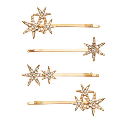 Set of gold hair pins with star designs on a white background