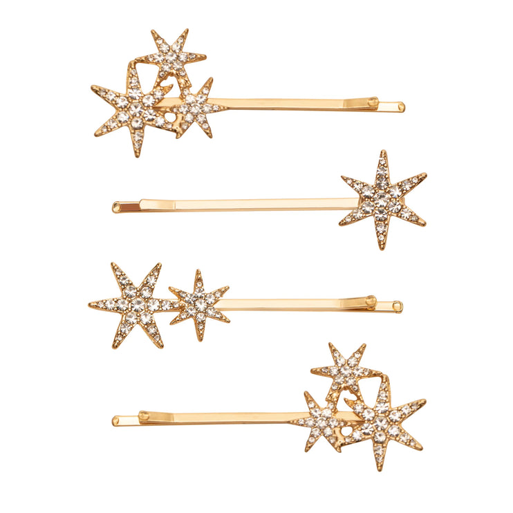 Set of gold hair pins with star designs on a white background