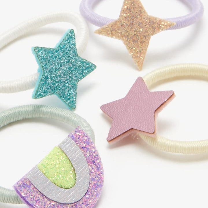 Five pastel hair ties including star and rainbow designs in glitter and matte finishes.