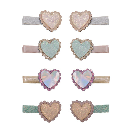 Set of eight heart-shaped hair clips. Feature glittery and iridescent heart designs in pastel shades of pink, blue, purple, and gold