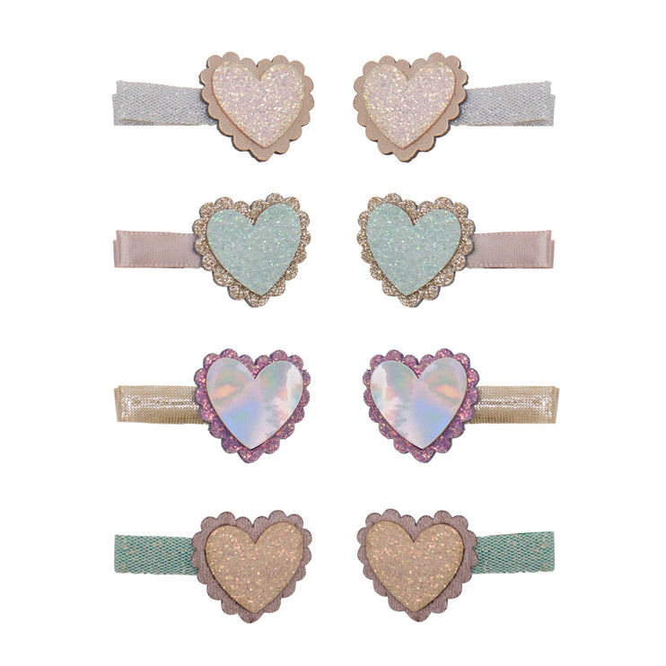Set of eight heart-shaped hair clips. Feature glittery and iridescent heart designs in pastel shades of pink, blue, purple, and gold