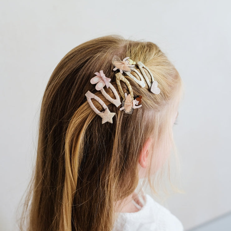 a kid wearing ballerina themed hair clip 