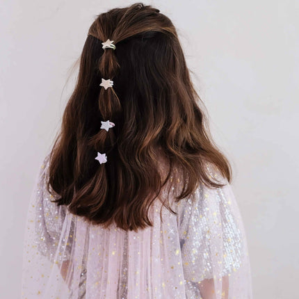 A girl with  four small white star hair clips