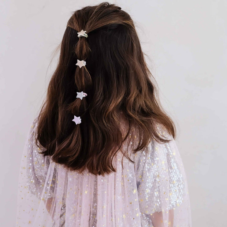 A girl with  four small white star hair clips