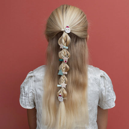 Kid with long blonde hair styled in braids with decorative hair clips