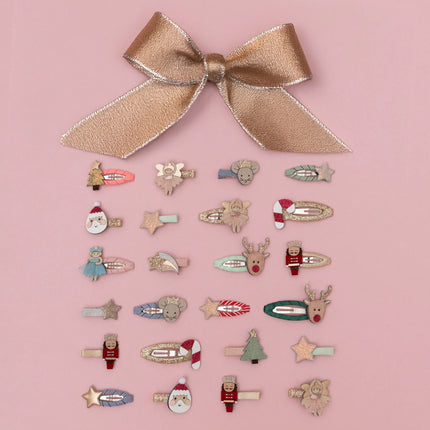 Collection of decorative christmas hair clips with a large bow on a pink background