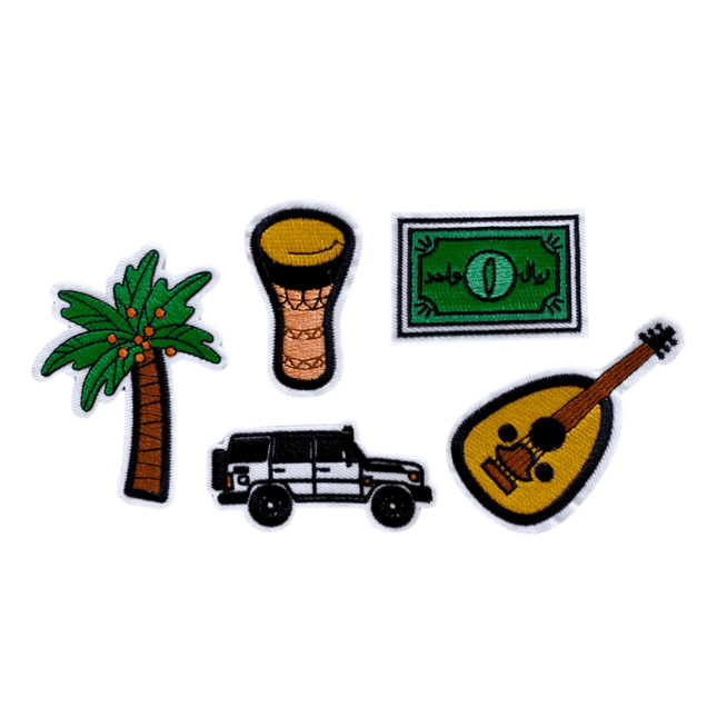 Set of five iron on patches for saudi national day including a palm tree, drum, money bill, jeep, and guitar