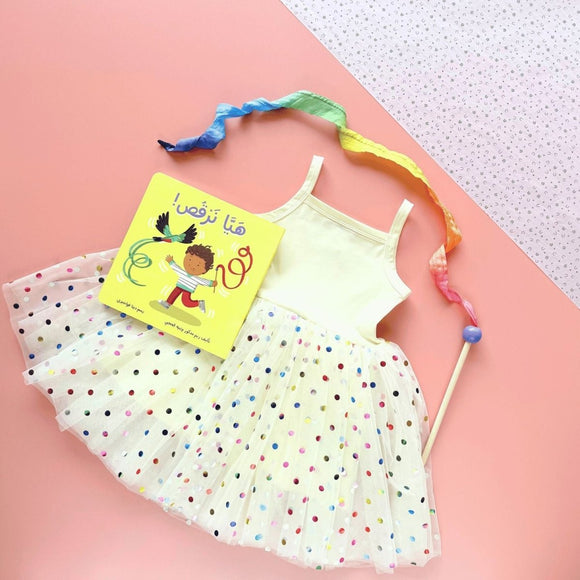 Children's dress with polka dots, a dance book, and a dancing ribbon