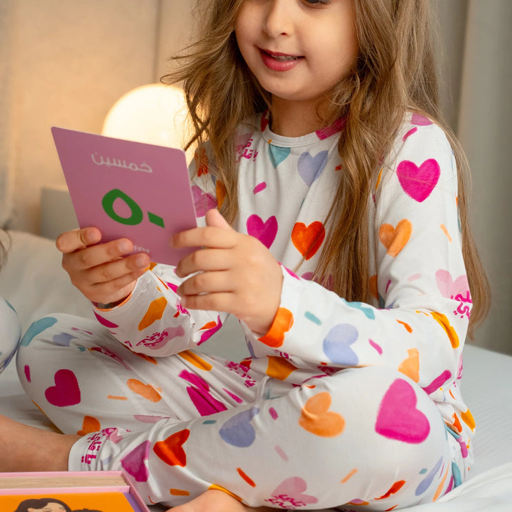 A child wearing Albi pajamas with colourful hearts.