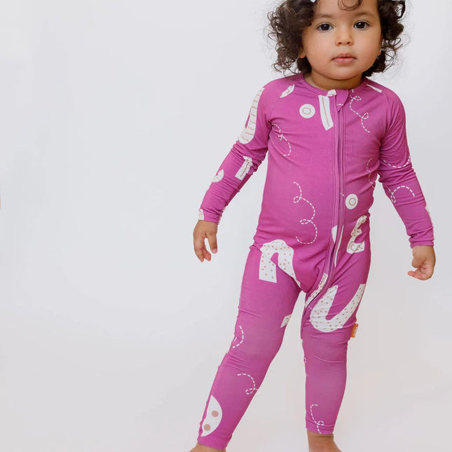 A baby wearing Arqam pink romper