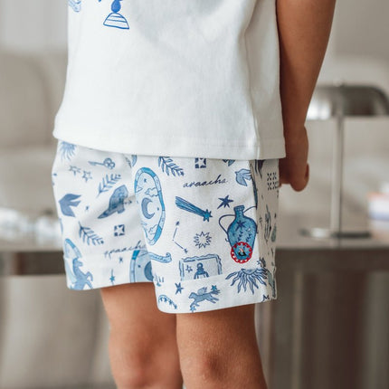 child wearing white shorts with celestial print