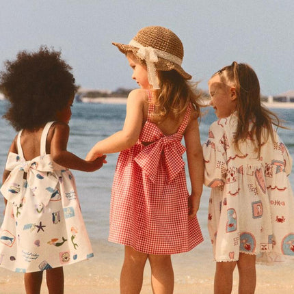 three kids in a beach wearing a unique dresses from avaacha