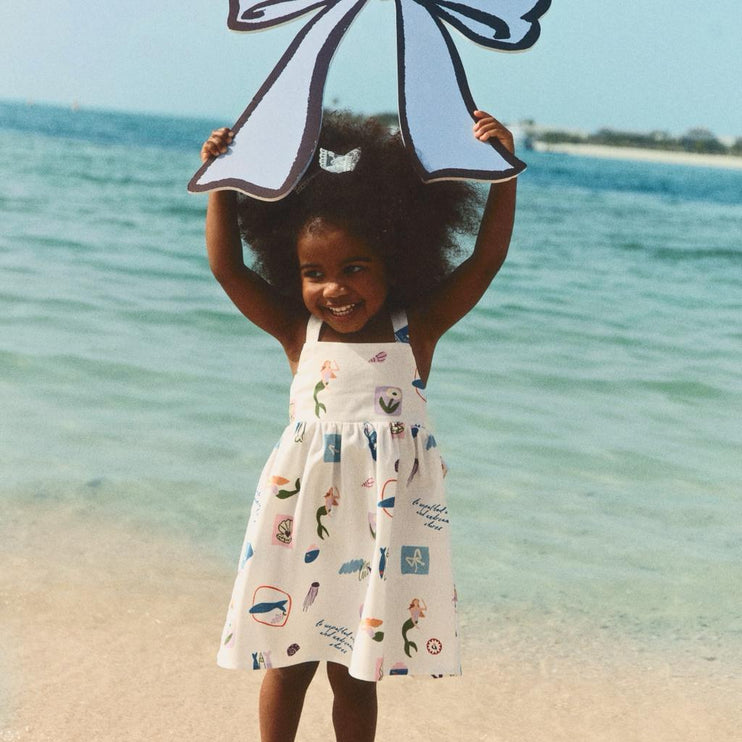 child wearing a white dress with cute pattern