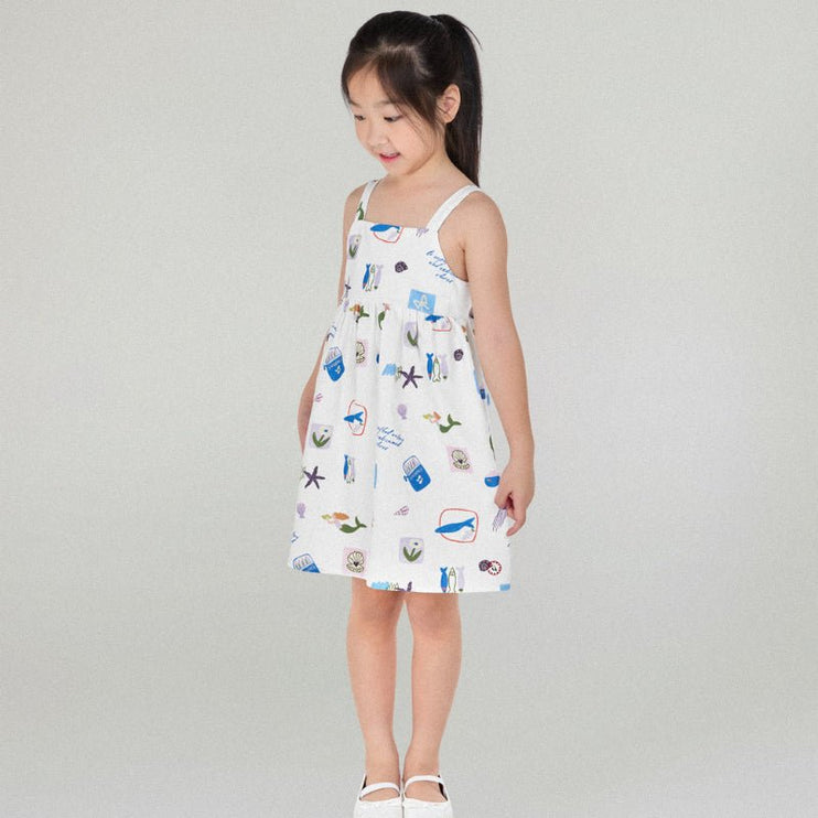 Young girl wearing a white dress with colorful patterns