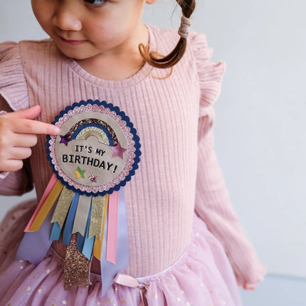 Kid with a birthday rosette