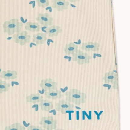 Off-white fabric with blue floral pattern and 'TINY' text