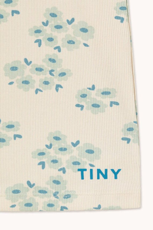 Off-white fabric with blue floral pattern and 'TINY' text