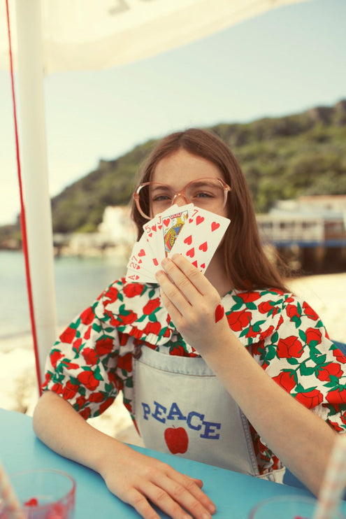 Girl wearing blouse with sailor collar with red roses