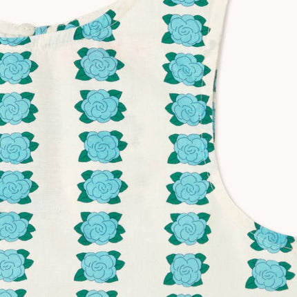 Off-white sleeveless top with blue flower pattern and 'tiny' print