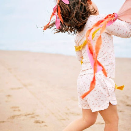 Playful baby girl wearing Cream with butterflies print longsleeves top and matching swim short