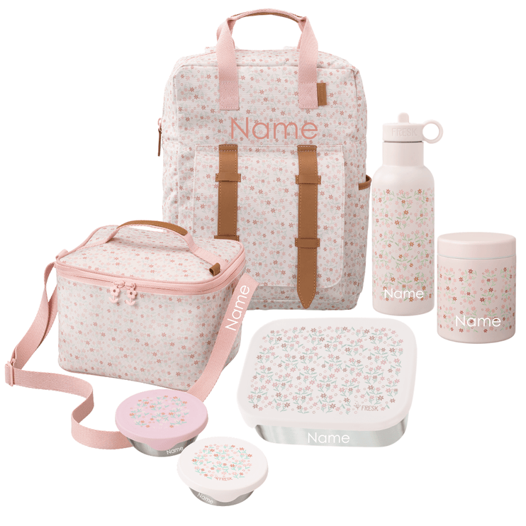 A coordinated school or picnic accessory set including a large backpack, a cooler bag, a water bottle, a lunch box with lid, a thermos food jar, and two snack boxes. The items are white with a small multicolor floral print and pink trim, with tan-brown strap accents. All Items can be personalized