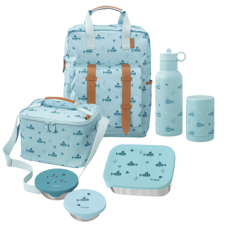 A coordinated lunch bag set on a white background, including a backpack, insulated lunch box, water bottle, travel tumbler, and two bento containers. The bags and containers are in a blue submarine print