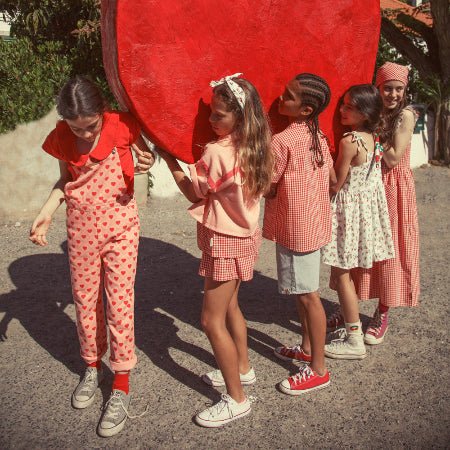 Girl wearing Pink Dungaress with red hearts all over