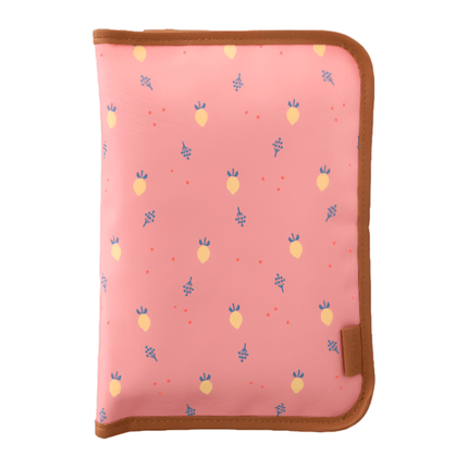 Folded peach changing mat with a summer fruit pattern and brown edges.