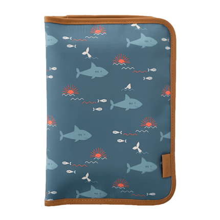 Folded navy blue changing mat with a sharks print pattern and brown edges.
