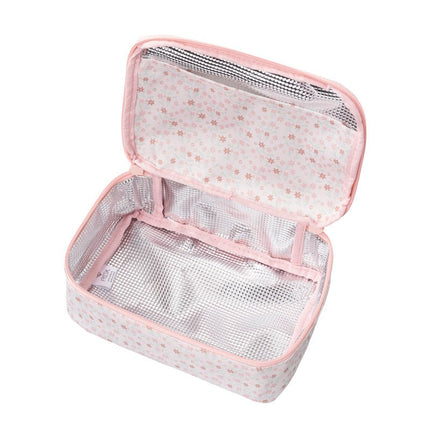 Open cream snack bag with a garden flowers pattern, revealing a silver insulated interior