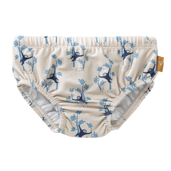 Cream with blue monkey print swim diaper pants for boys with UV protection 50. Made of eco-friendly recycled nylon, with an absorbent inner layer keeping your little one safe, dry, and comfy for splashy beach or pool fun.