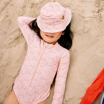 Girl wearing Peach Longsleeve Swimsuit & matching Bucket hat with Mimosa print 