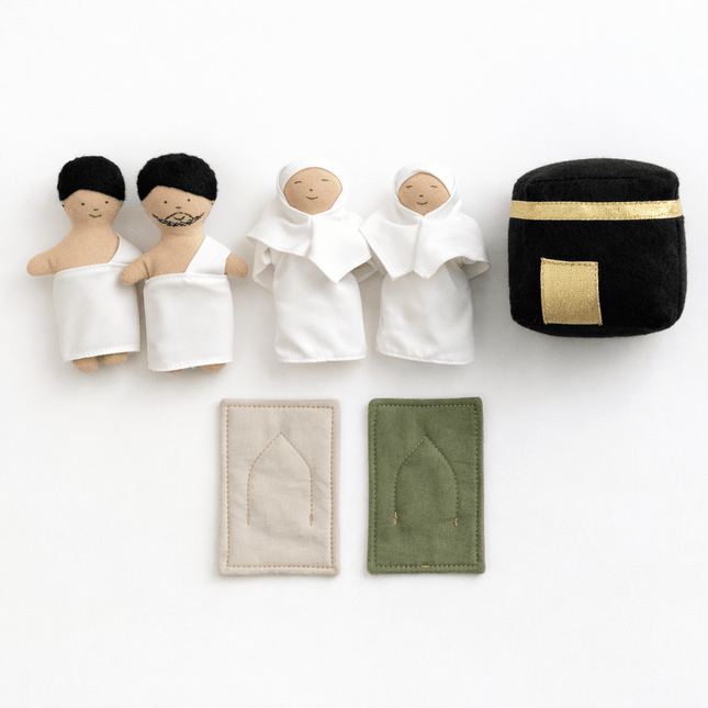 Set of small dolls with different clothing items on a white background