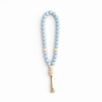 Beaded masbaha with a tassel on a white background
