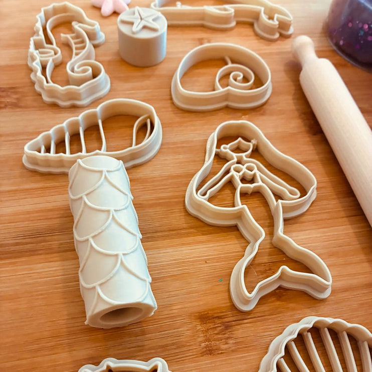 A set of cutters and a wooden rolling pin 