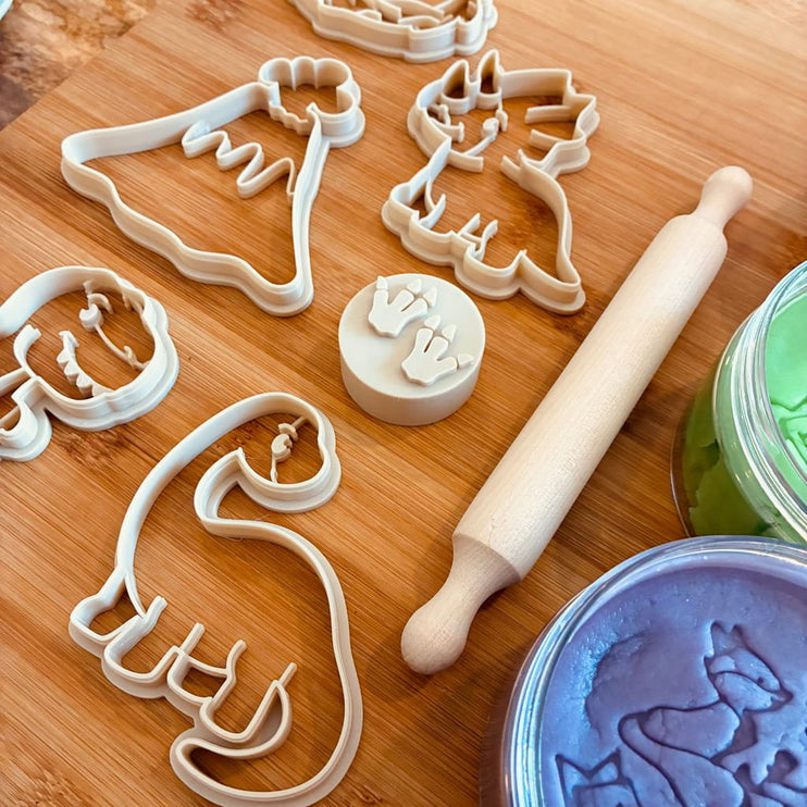 dinosaur-themed cookie cutters and a matching round stamp 