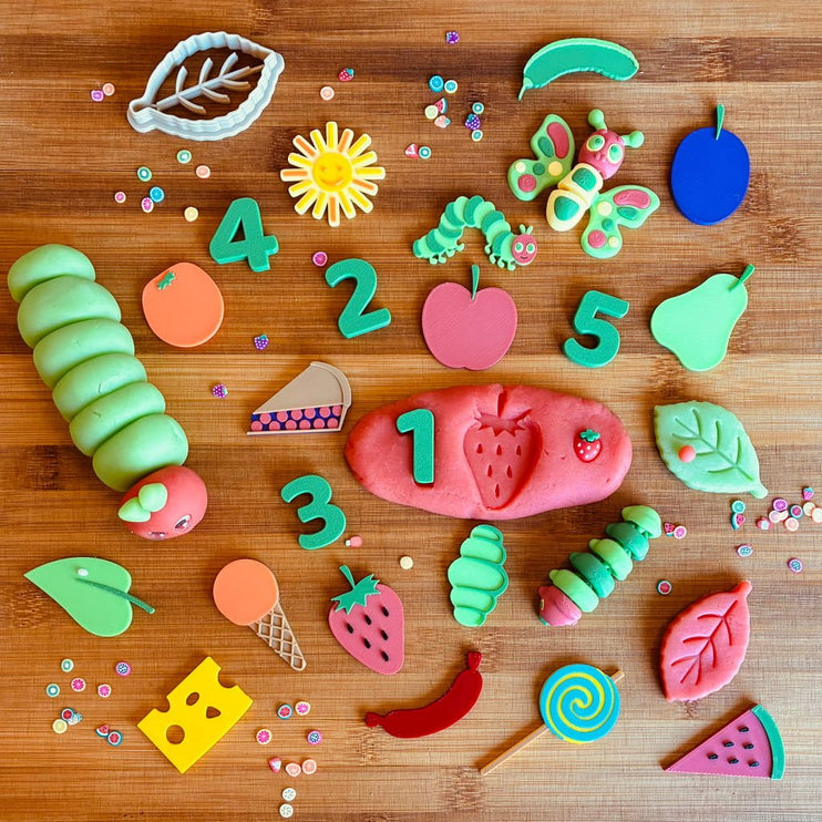 Colorful cookie cutters shaped like numbers, fruits, and vegetables 