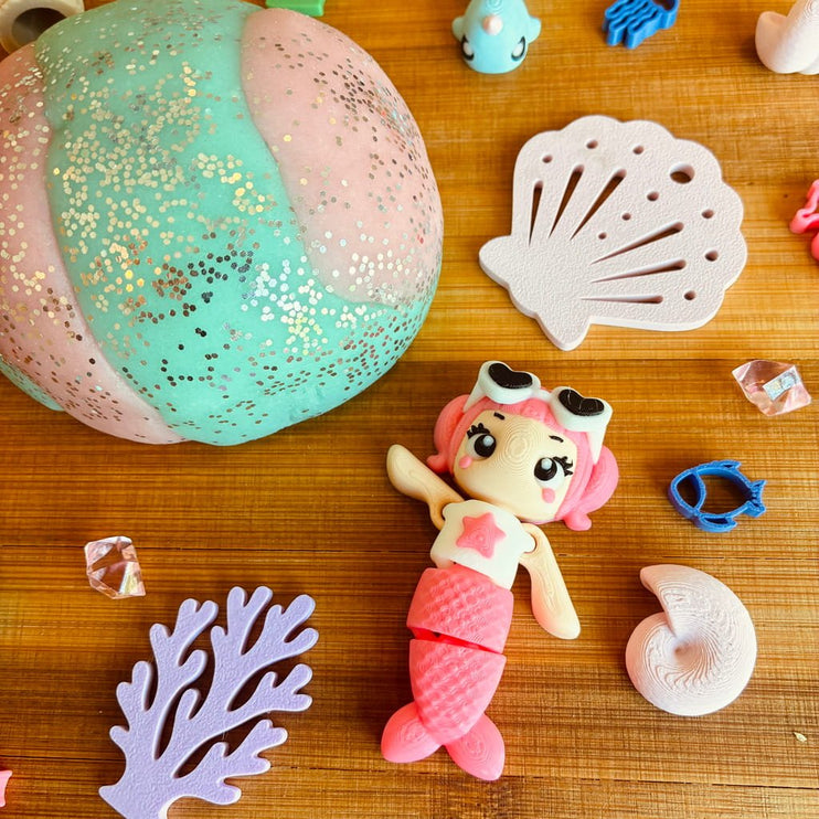 Mermaid-themed play dough figure with beach ball and shell toys 