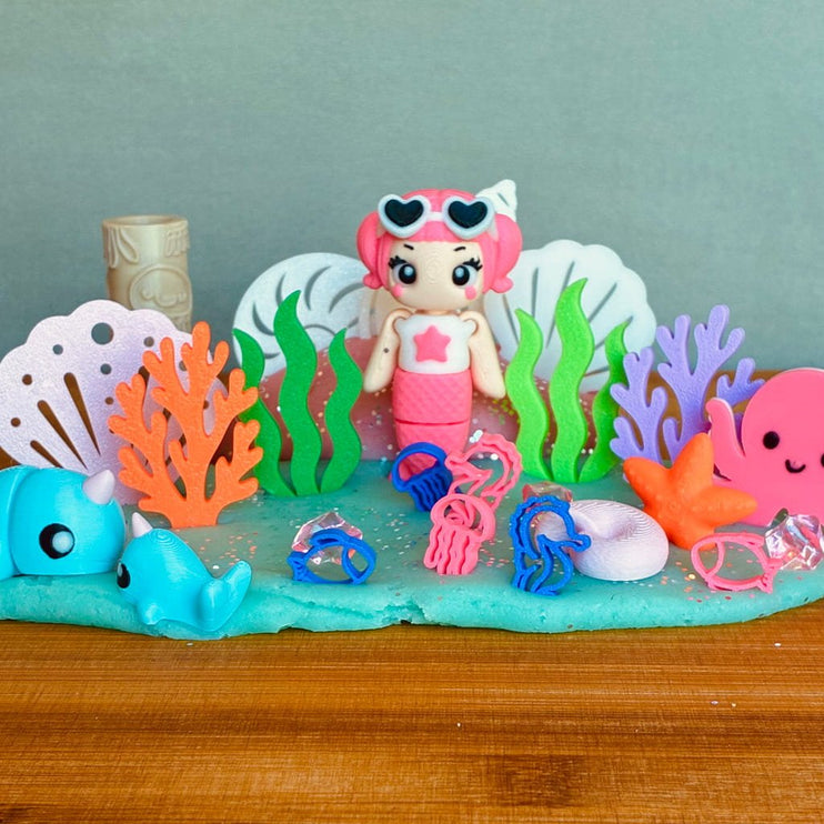 Toy mermaid with accessories on a colorful underwater-themed display