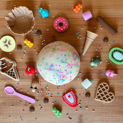 Colorful dough ball with sprinkles with toy cookie cutters 