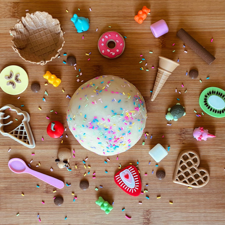Colorful dough ball with sprinkles with toy cookie cutters 