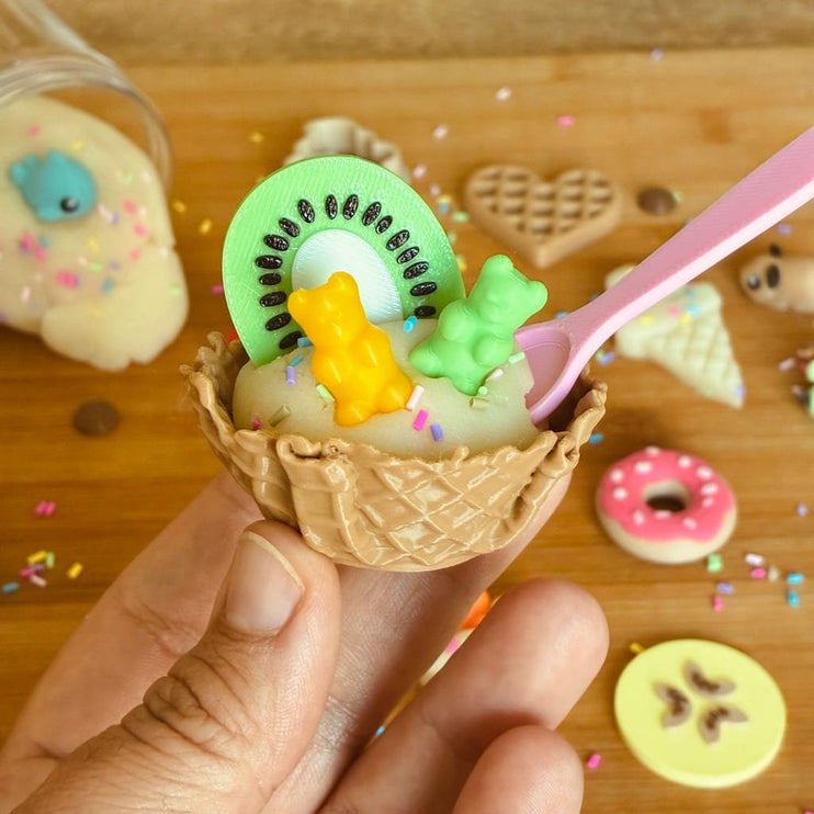 Waffle cone with ice cream and toy kiwi