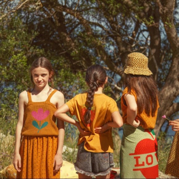 Girl wearing Camel knitted top with straps and flower print