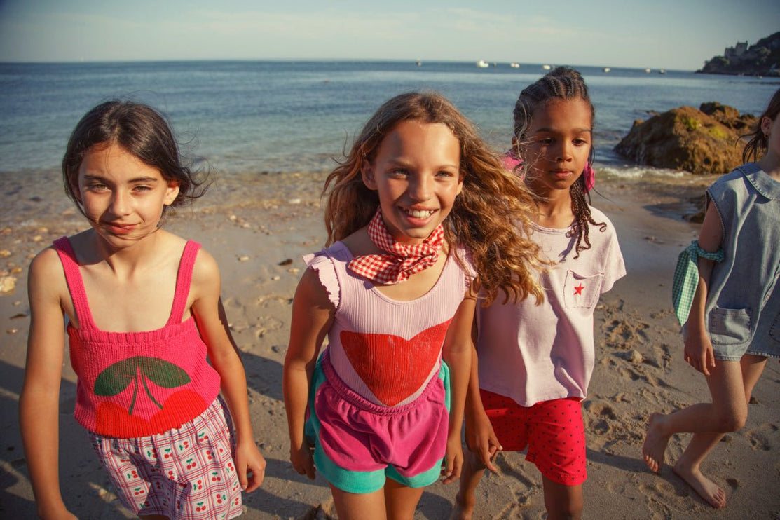 Girl wearing pink knitted top with straps and Cherry Print