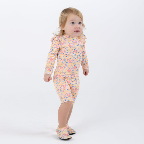 a baby girl wearing the baby swimsuit ruffles